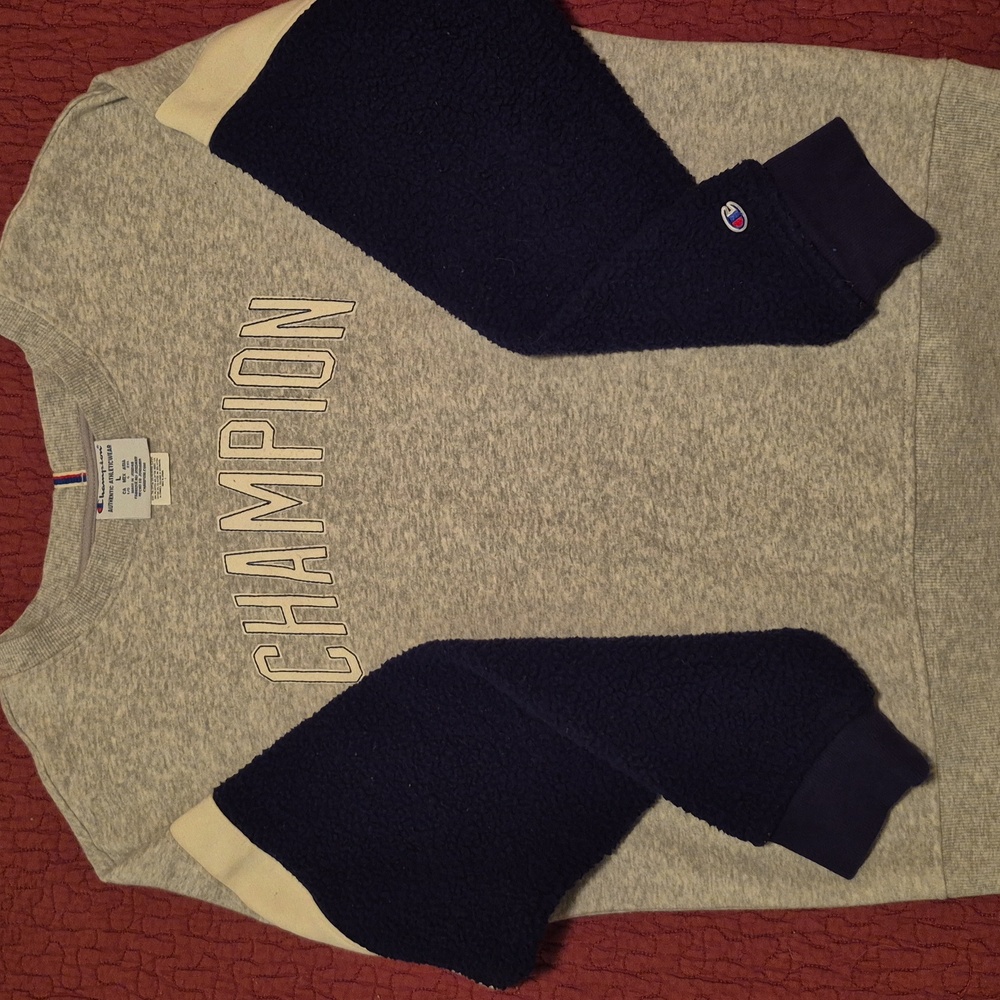 Champion sweat shirt. Large sleeves are fleece . Grey body. Dark blue sleeves.
